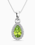 Silver pendant with a green peridot gemstone on a white background