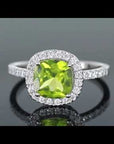 Video thumbnail of Cushion Cut Peridot Ring in Sterling Silver, featuring a vibrant peridot gemstone with a halo of diamond alternatives.