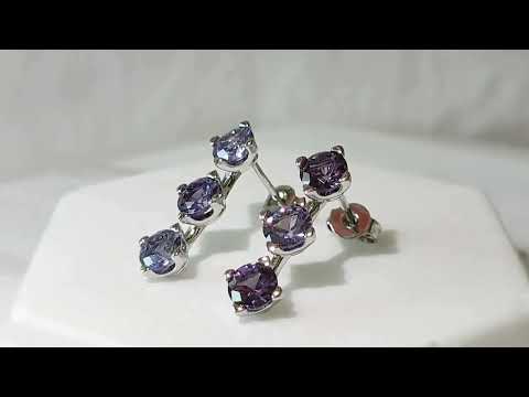Video preview of Alexandrite three-stone earrings showcasing colour shift and sparkle under light