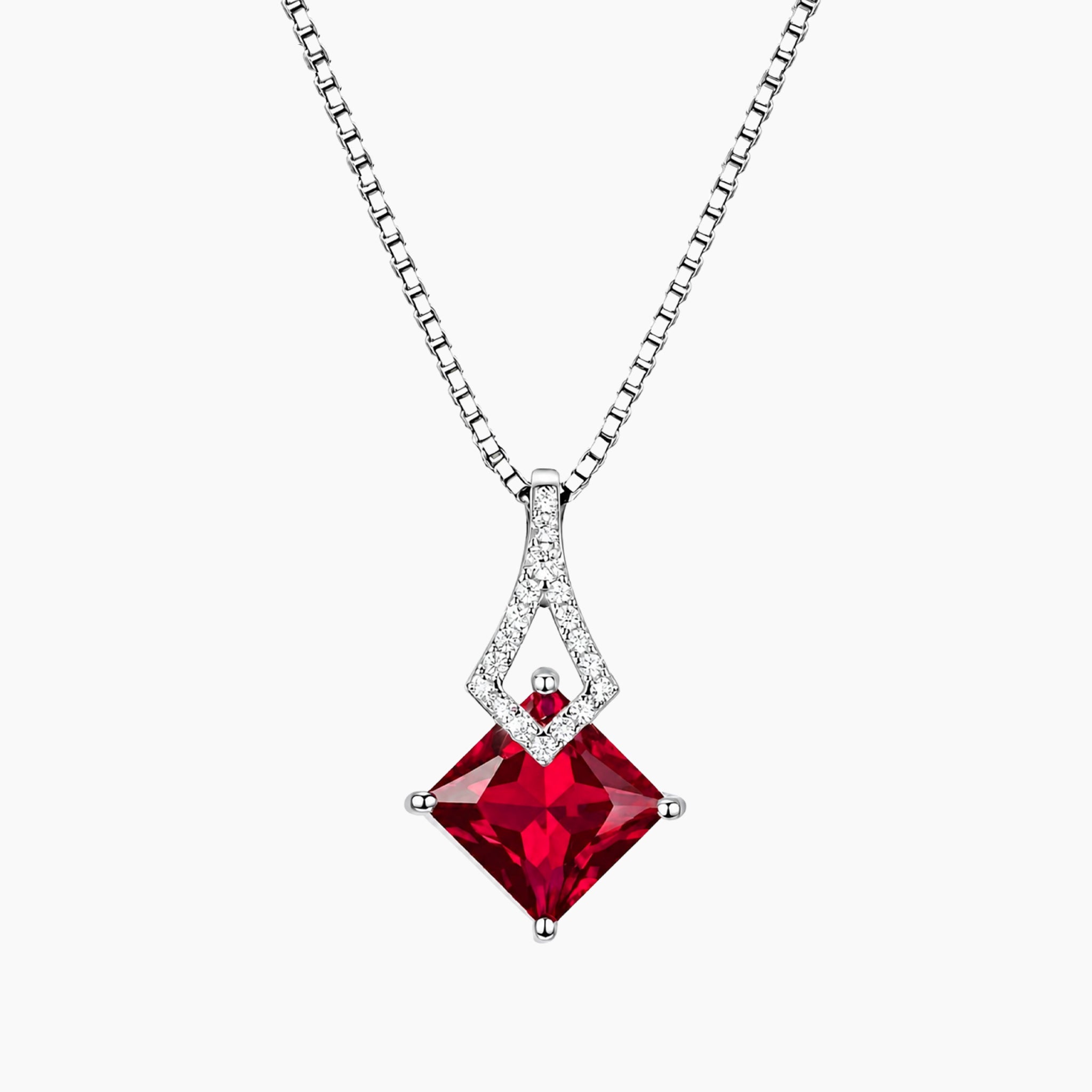Red princess cut ruby gemstone pendant on a silver chain against a white background