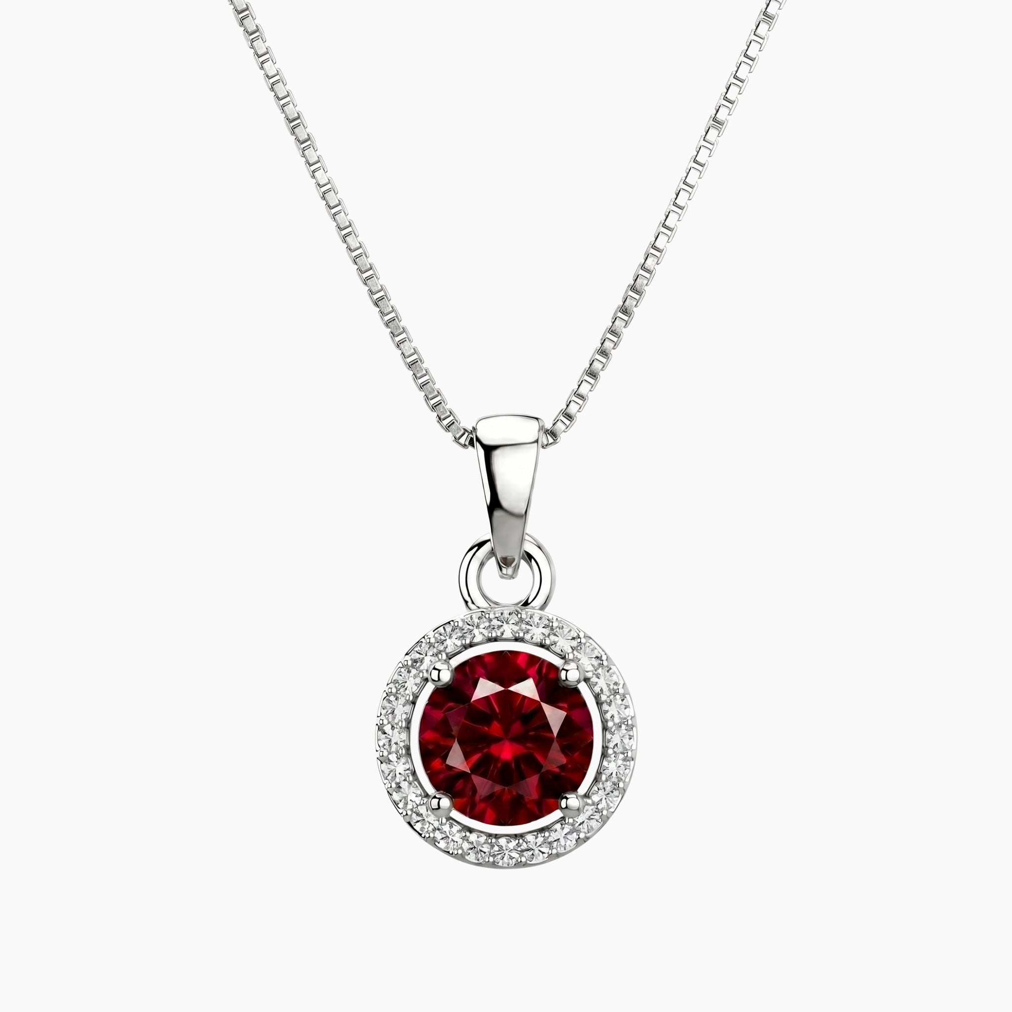 Silver necklace with a red round ruby gemstone halo pendant on a white background