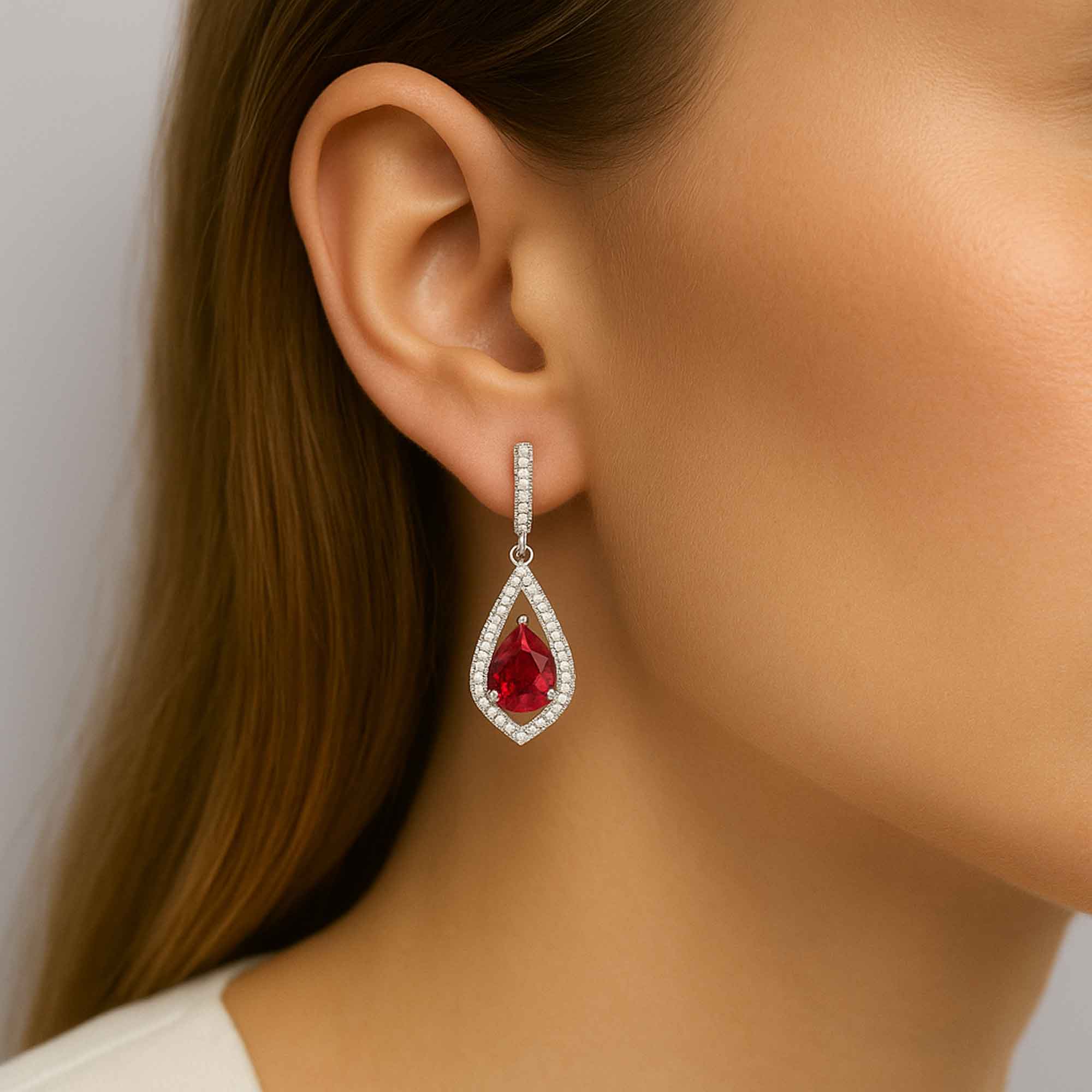 pear shape ruby dangling earrings on model ear