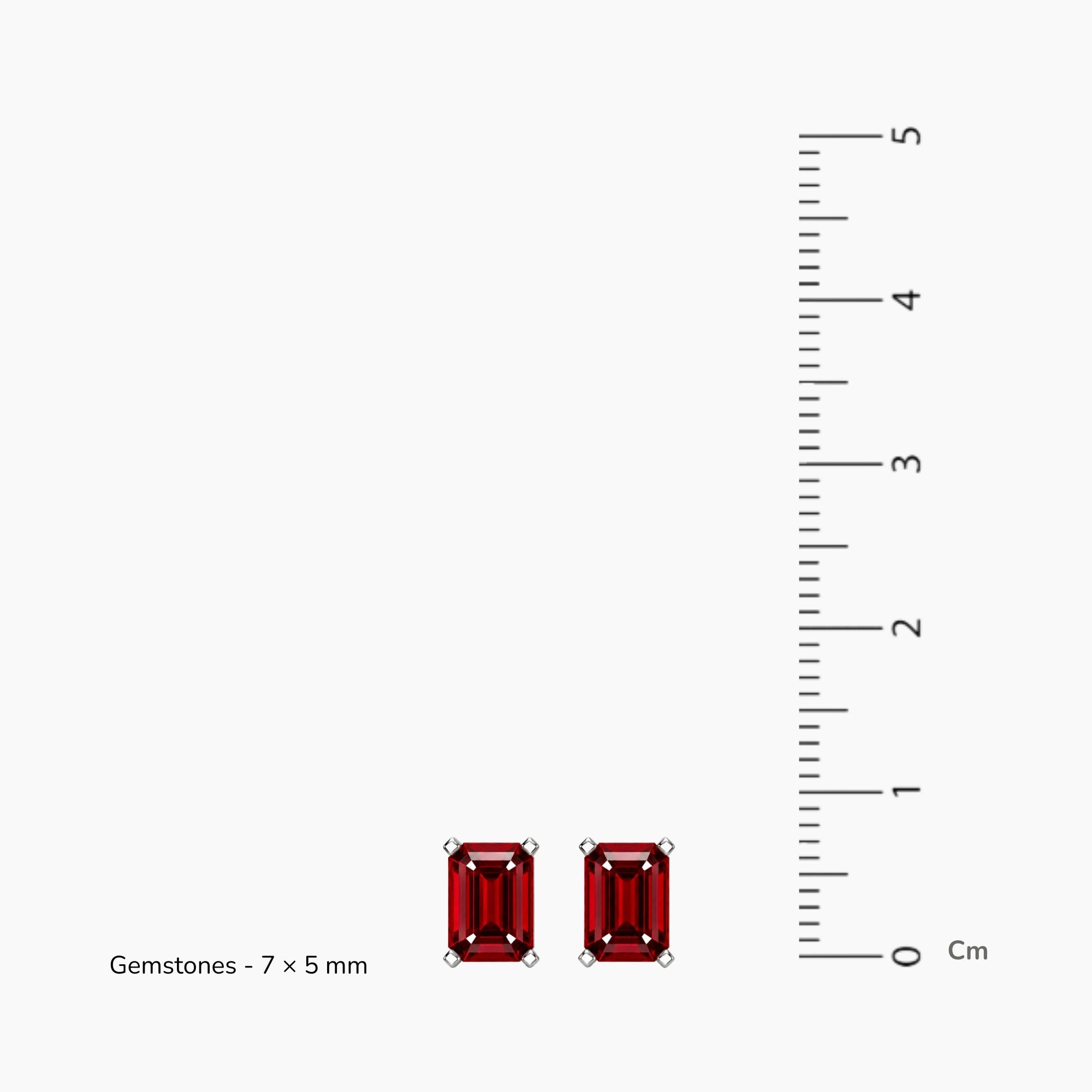 emerald cut ruby earrings next to scale measuring 7mm 5mm