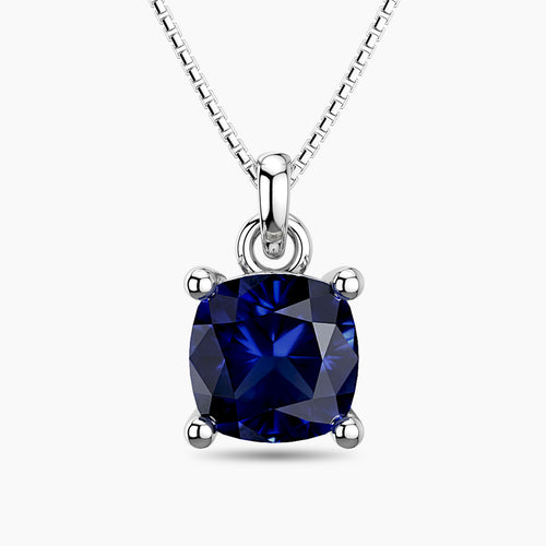 Cushion-cut sapphire pendant in sterling silver with a box chain, featuring a deep blue gemstone in a timeless four-prong setting.