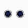 Pair of sapphire earrings with diamond halo on a white background