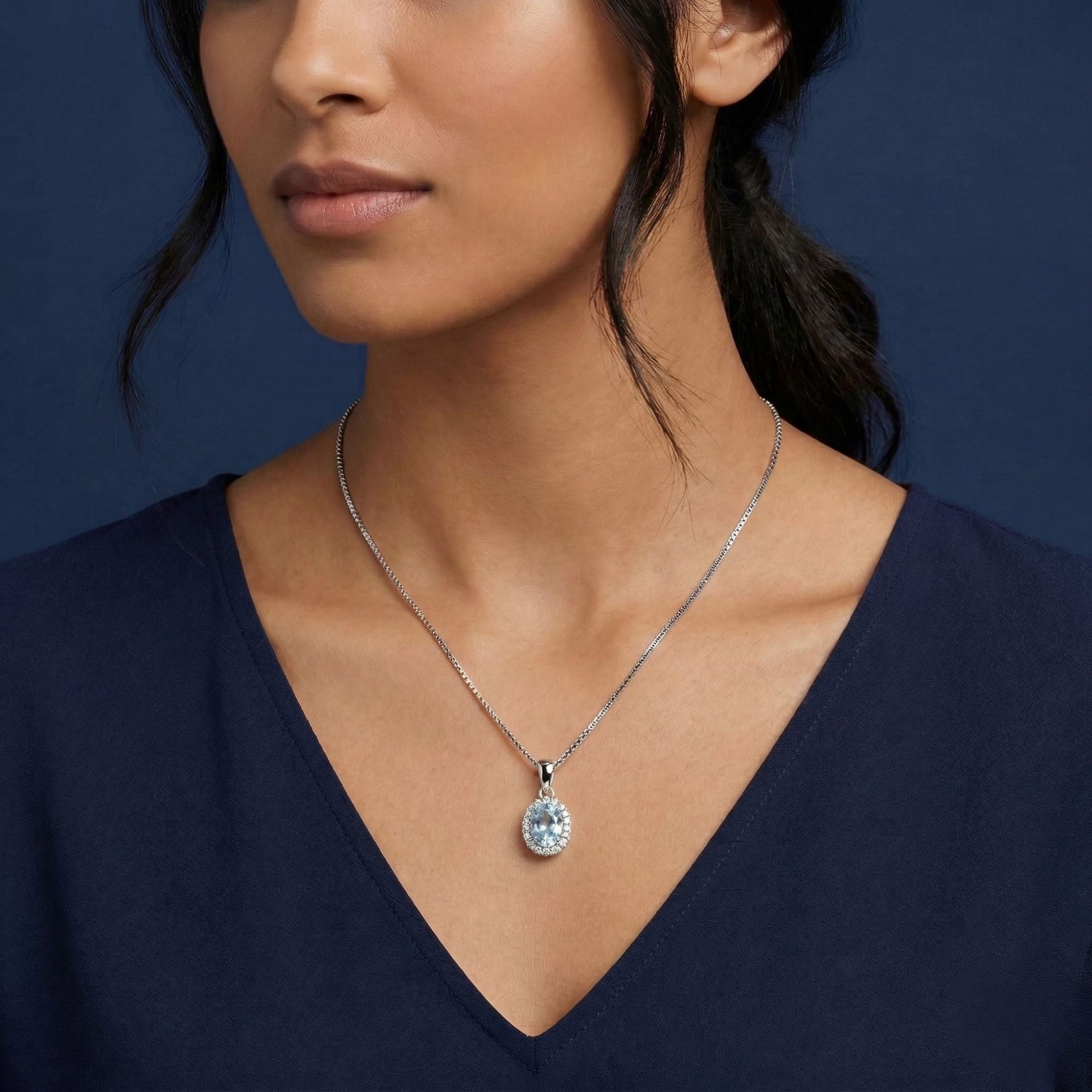 women model wearing oval shape aquamarine pendant necklace in silver