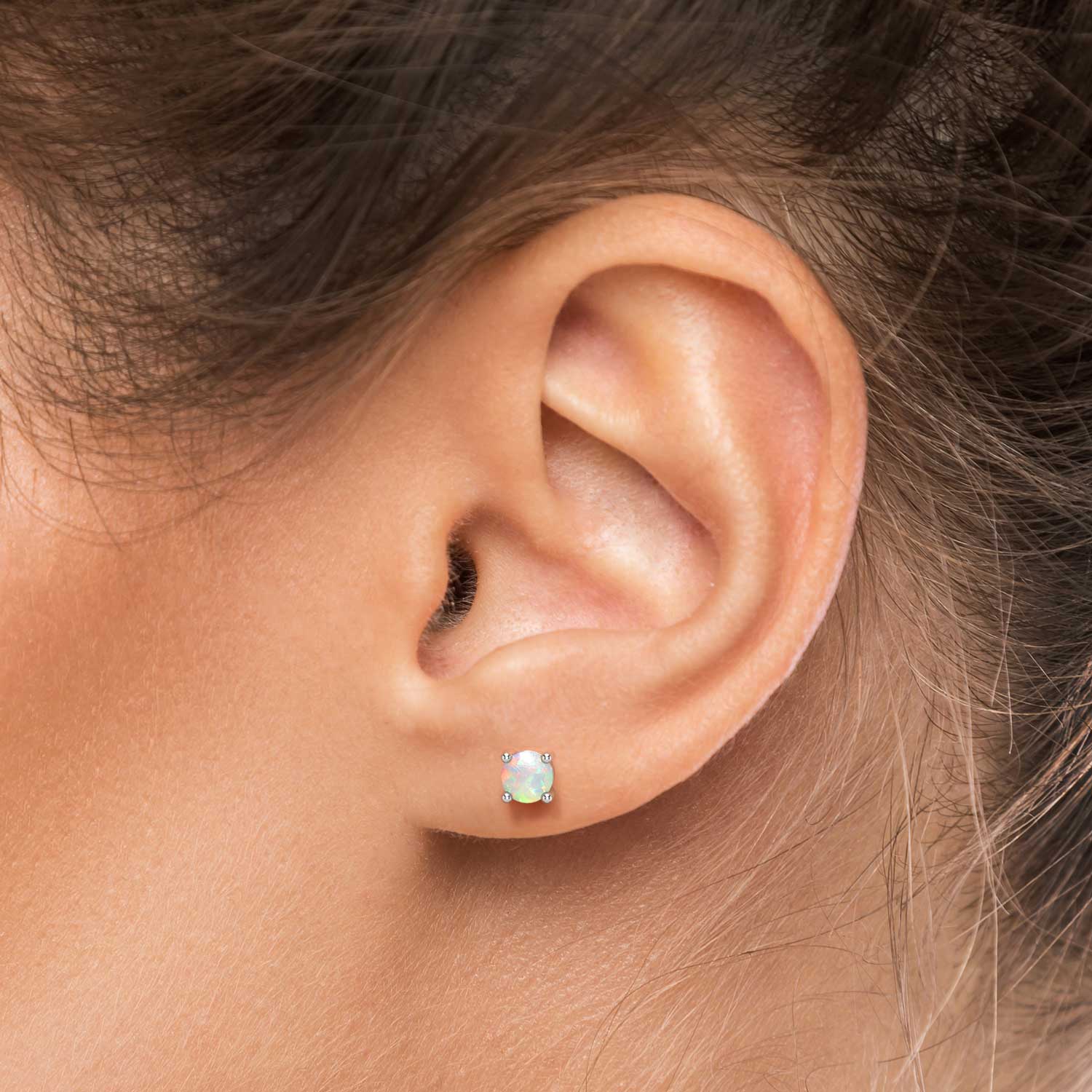 white opal earrings on model