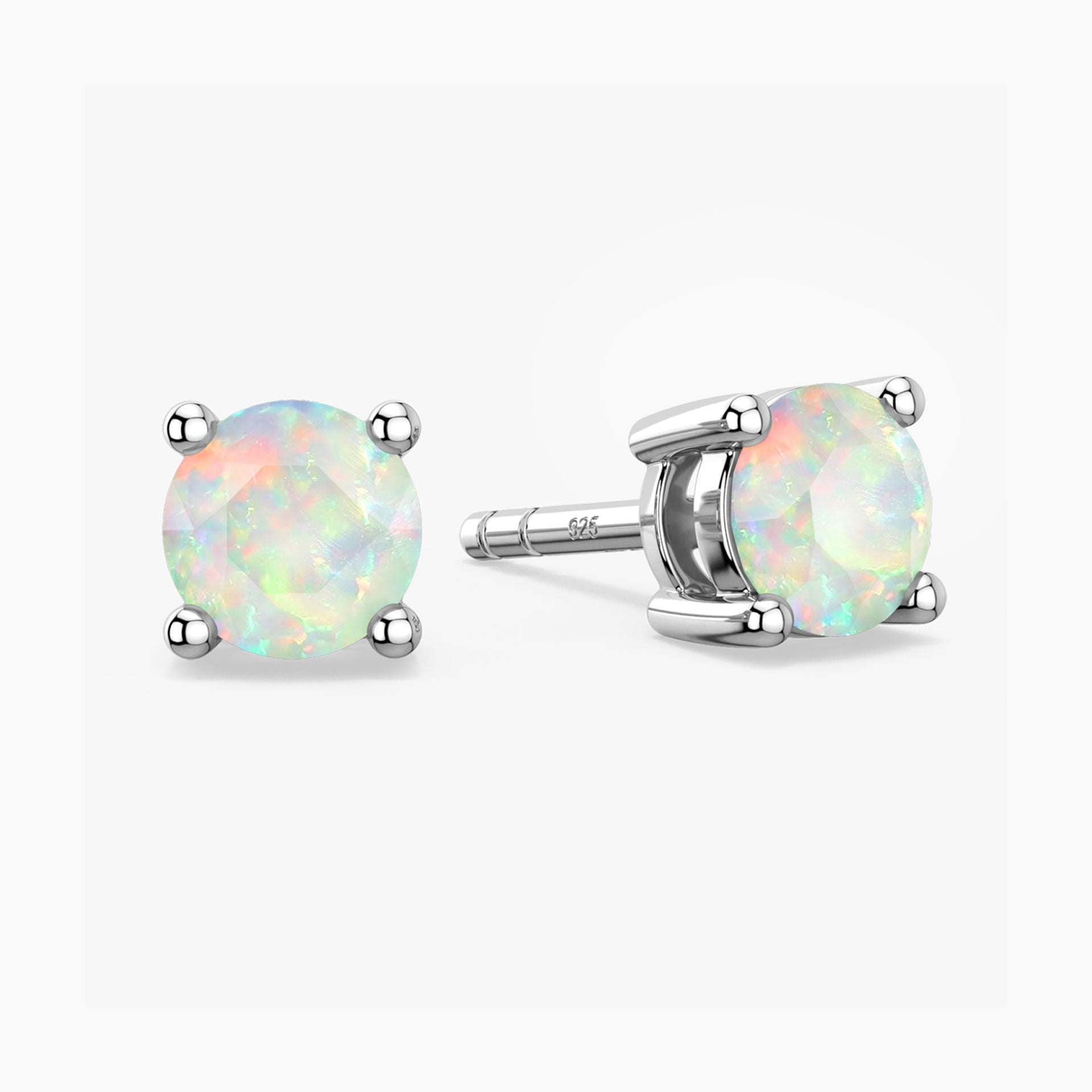 Pair of opal stud earrings on a white background