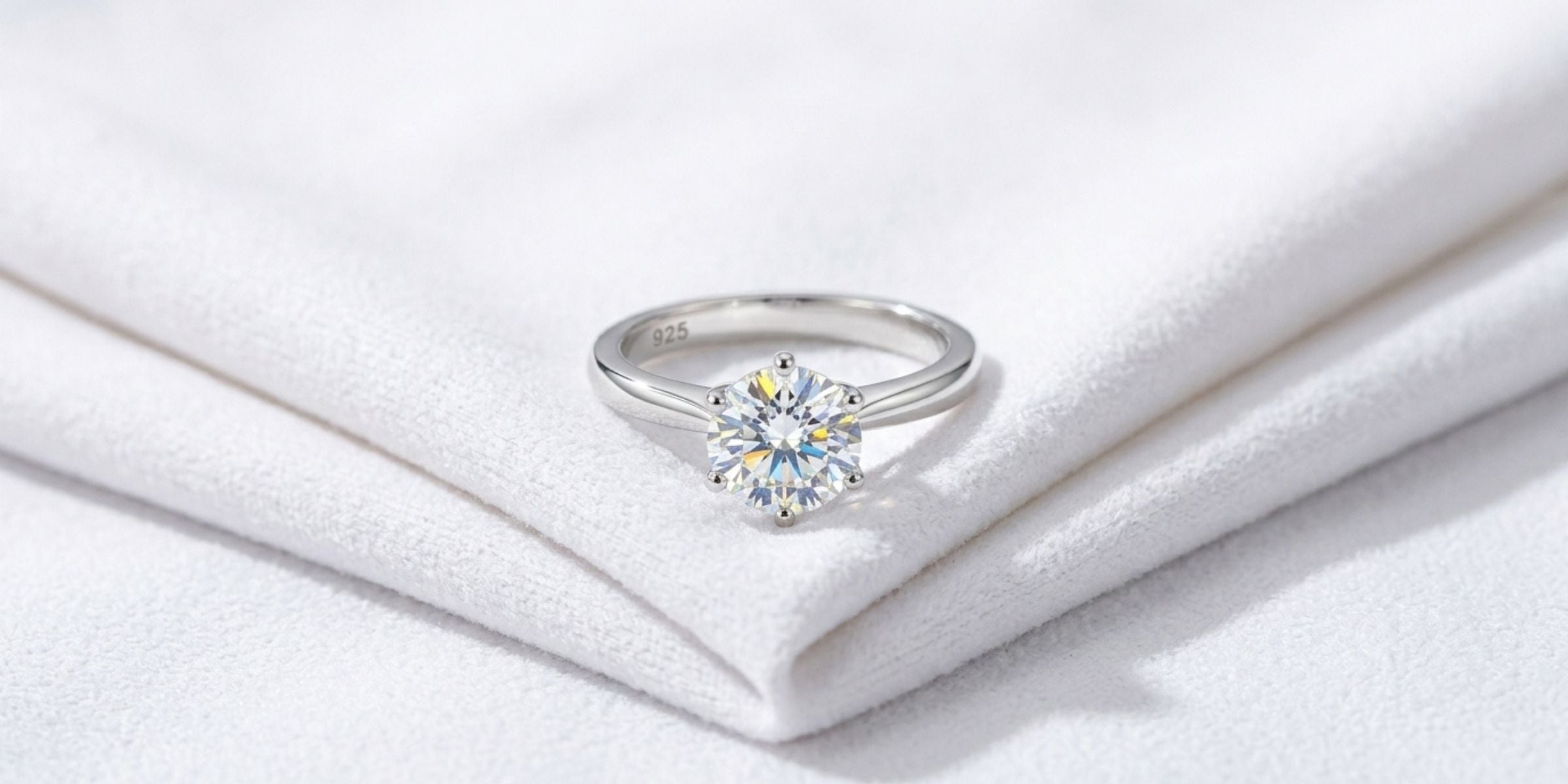 Sterling silver moissanite ring on a soft white polishing cloth