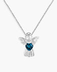 Silver angel pendant with a blue topaz heart-shaped gem on a white background