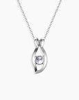 Back side view of alexandrite evil eye necklace in silver showing colour-shifting gemstone in sculpted setting