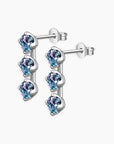 Side angle of Alexandrite three-stone stud earrings with round gemstones in rhodium-plated silver