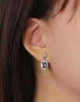 Oval Alexandrite drop earrings worn on ear – elegant gemstone jewellery for June birthdays