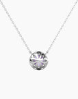 Close-up of halo necklace backside with round Alexandrite gemstone and shimmering CZ border in silver