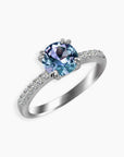 Side angle view of Alexandrite solitaire ring with pavé CZ band and rhodium-plated silver setting