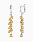 dron and side view of citrine drop earrings on light background