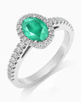Angled view of the sterling silver emerald halo ring, showing the 4-claw setting and shimmering CZ accents.