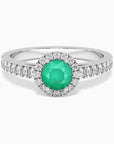 Sterling silver round-cut emerald halo ring with a natural Sakota emerald center stone surrounded by CZ.