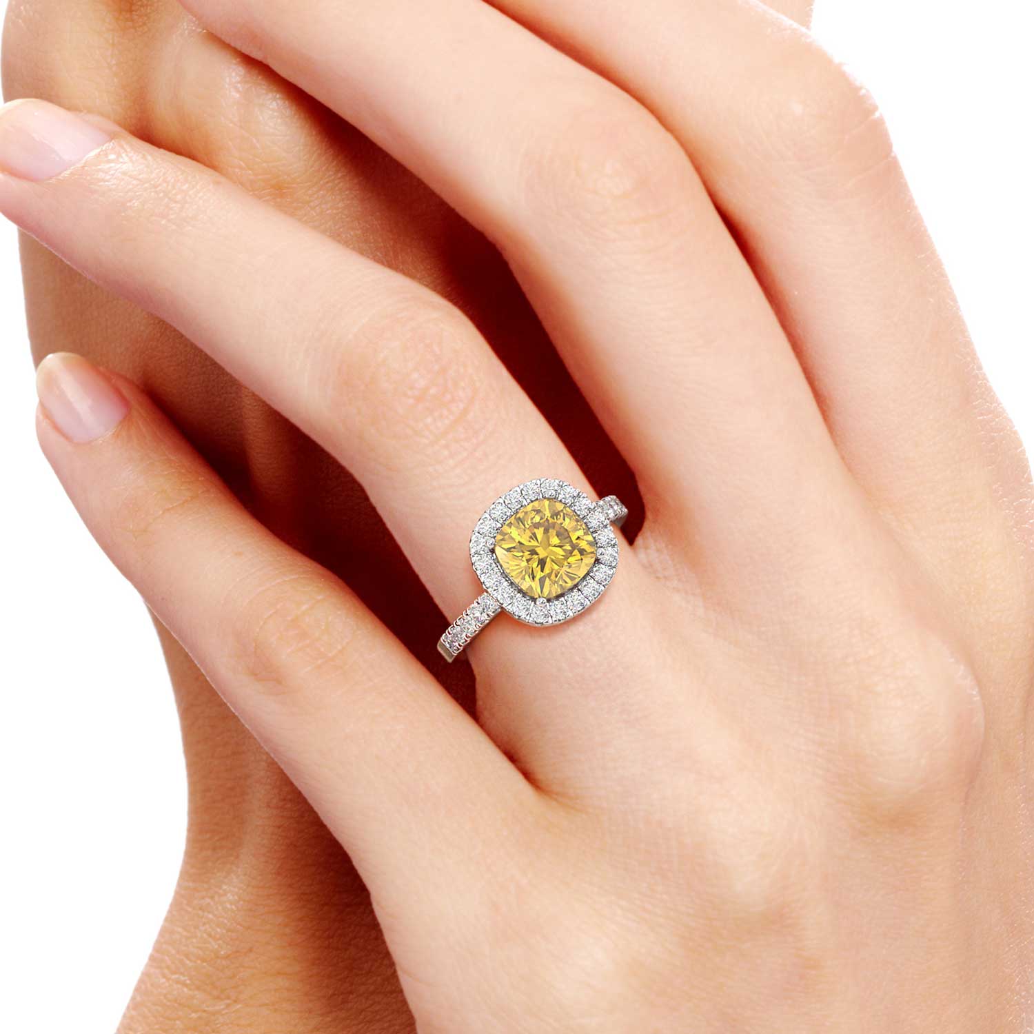 A stunning cushion-cut citrine halo ring, gracefully showcased on the hand. The warm and radiant glow of the citrine gemstone, encircled by sparkling diamonds, exudes elegance and charm, making it a captivating accessory.