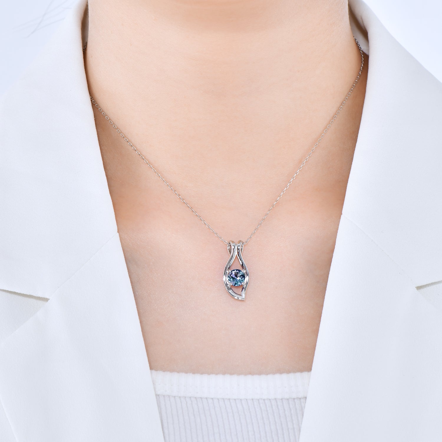 photo of a lady wearing evil eye pendant in white clothes