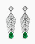Sterling silver feather-motif drop earrings with pear-shaped emeralds on a white background.
