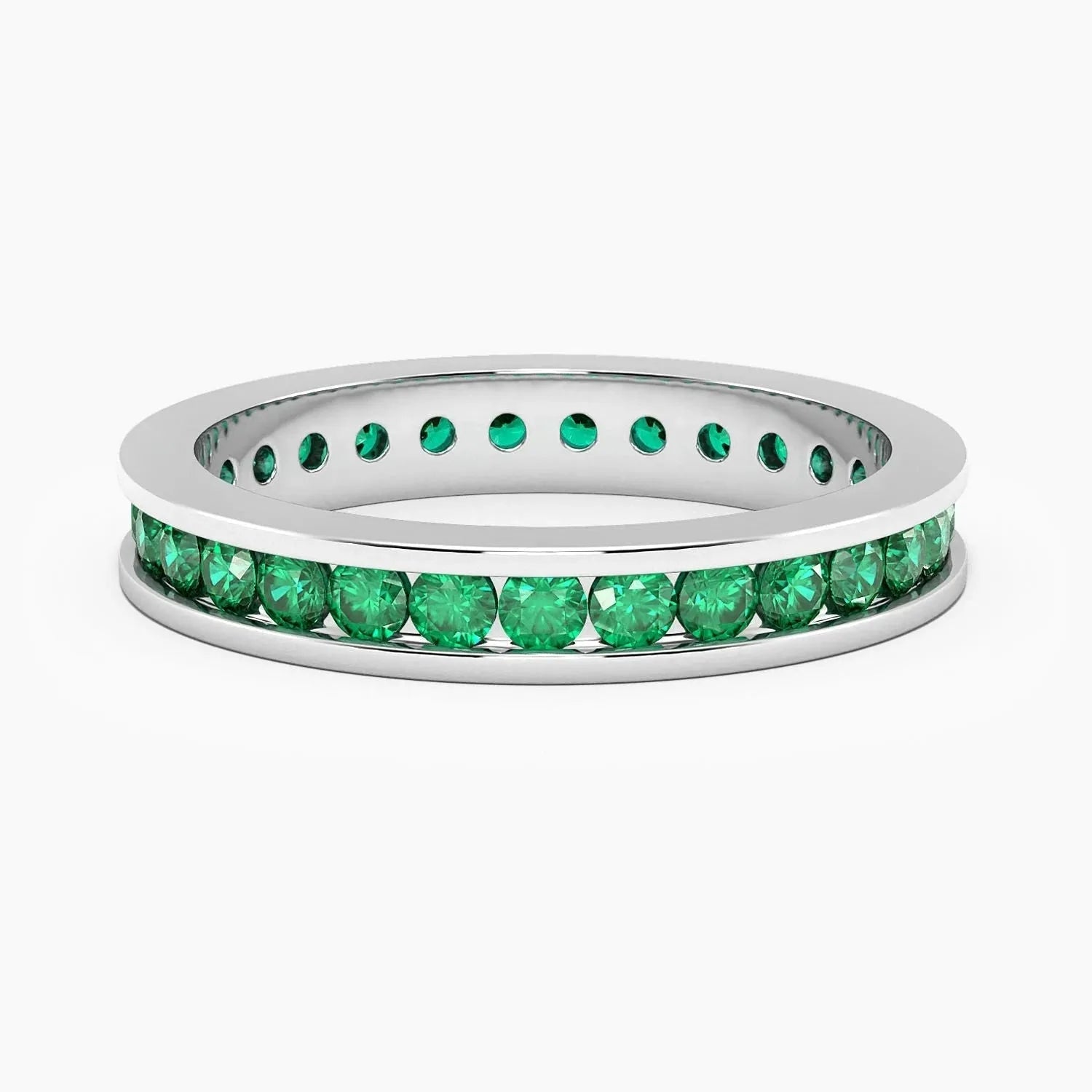 Sterling silver channel-set ring featuring vibrant lab-created emeralds.