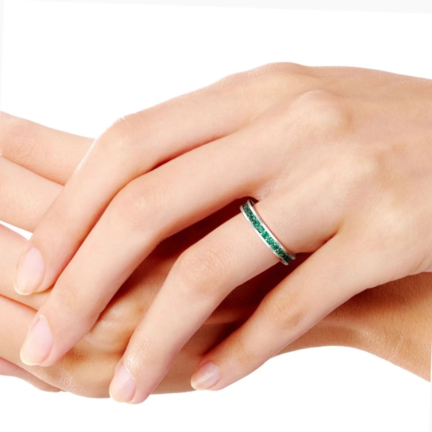 Woman wearing the sterling silver emerald channel-set ring on her hand, showing its elegant fit and sparkle.