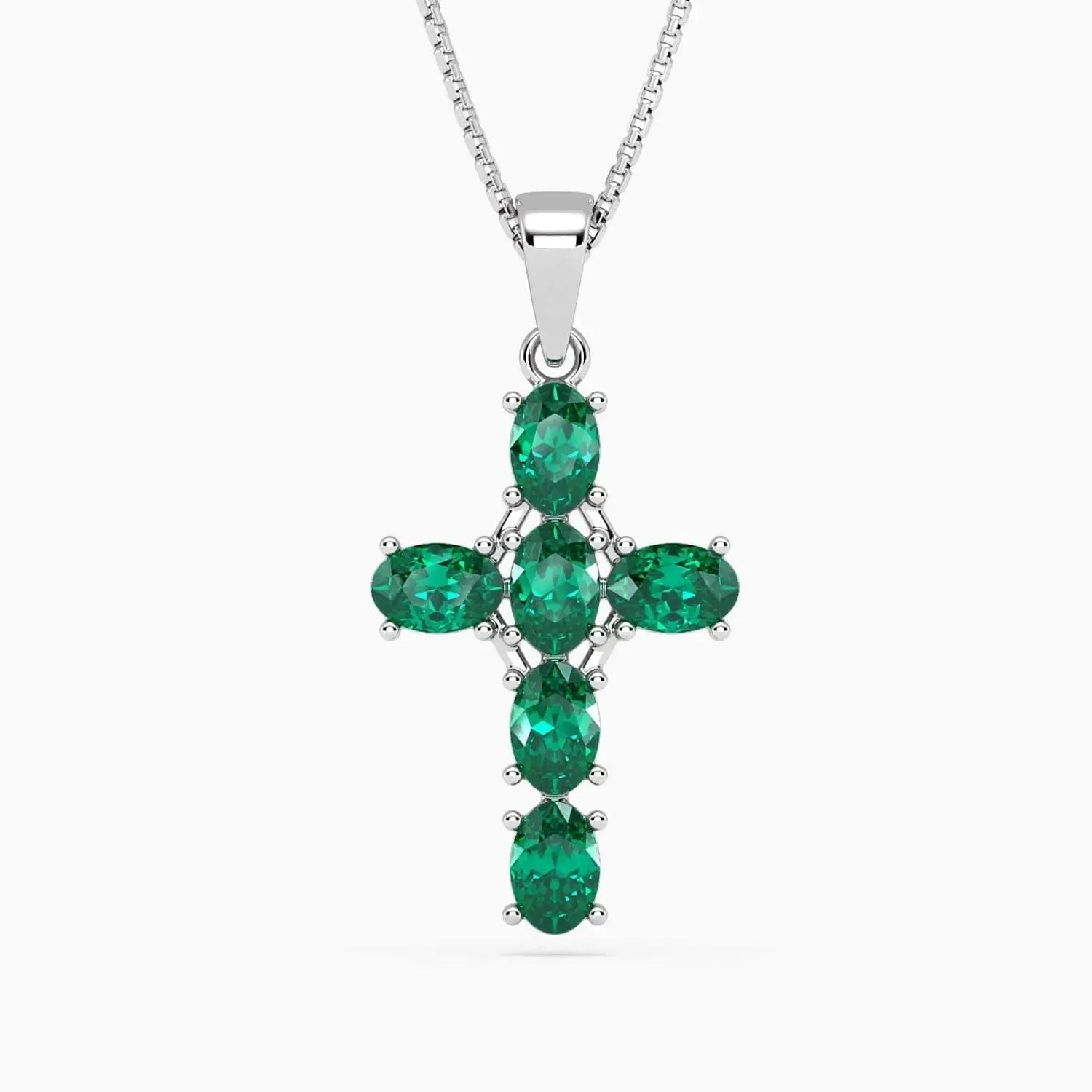 Sterling silver cross pendant with six oval emeralds displayed against a dark background.
