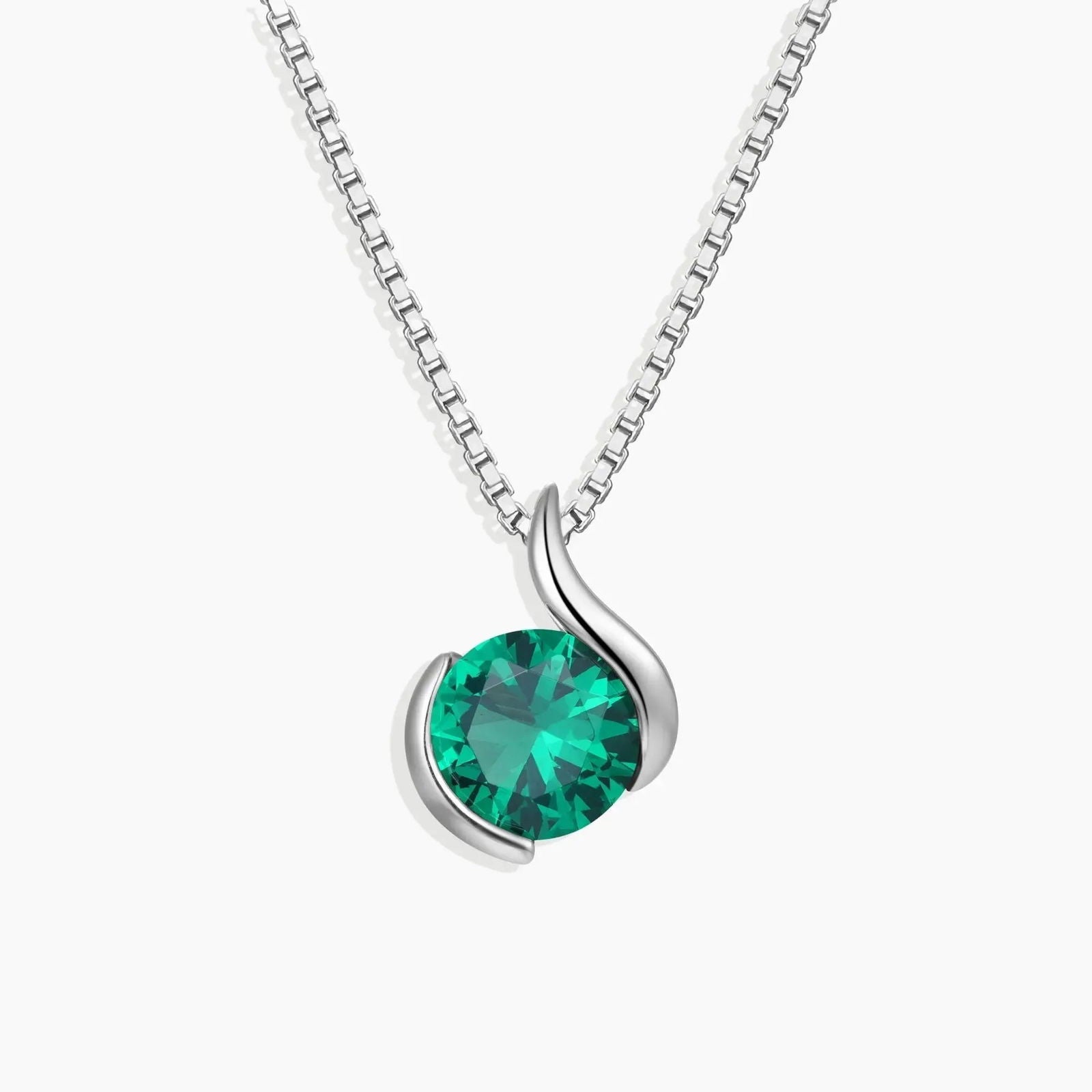 Sterling silver swirl pendant necklace with a round-cut emerald center stone.