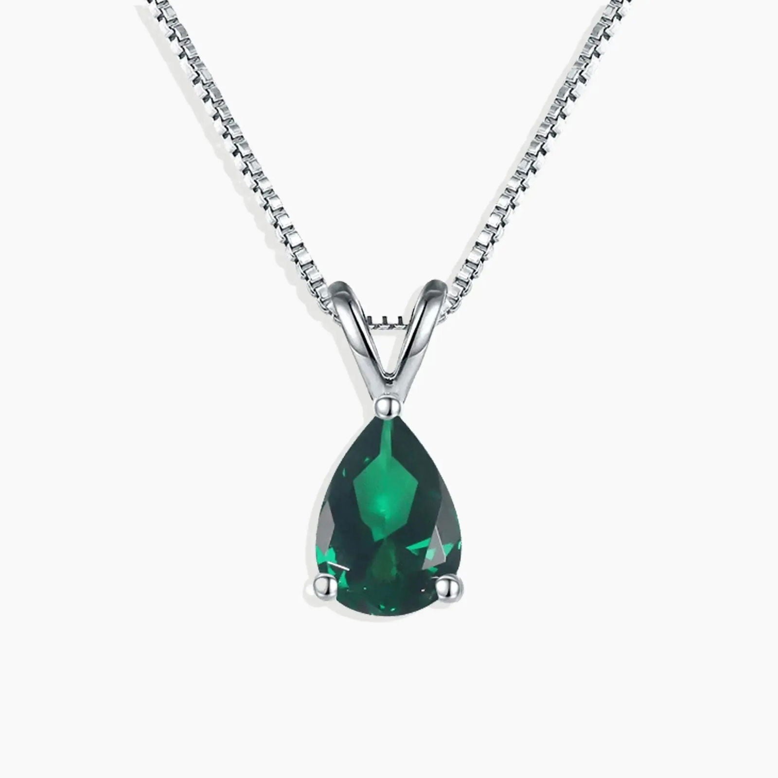 Sterling silver necklace featuring a pear-cut emerald pendant on a white background.