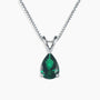 Sterling silver necklace featuring a pear-cut emerald pendant on a white background.