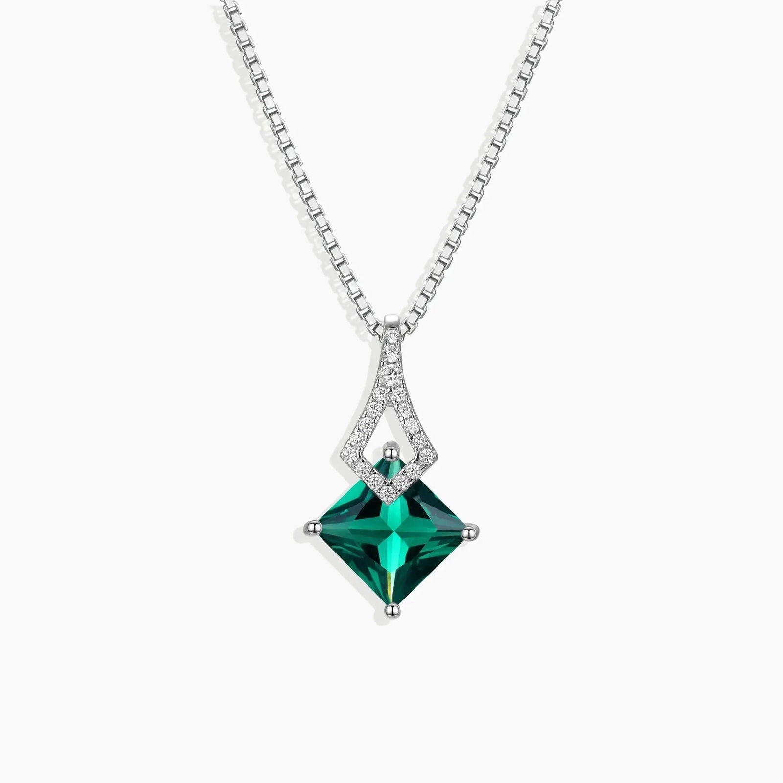 Sterling silver arrow-shaped pendant featuring a princess-cut emerald, displayed on a box chain.