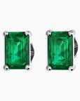Sterling silver stud earrings featuring emerald-cut emeralds on a white background.