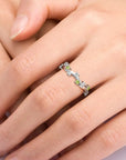 Close-up of a peridot ring worn on hand, featuring a celestial design with white zirconia stones.