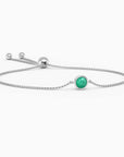 Sterling silver bracelet with a single round emerald gemstone, featuring a box chain and adjustable slider clasp