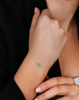 Woman wearing the sterling silver emerald bracelet on her wrist, highlighting the vibrant green gemstone