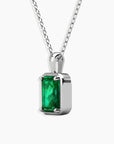 Angled close-up showing the prong setting and sparkle of the emerald-cut pendant.