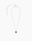 Sterling silver chain laid out with the emerald-cut pendant to display clasp and chain details.