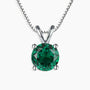 Sterling silver necklace featuring a round-cut emerald pendant on a white background.