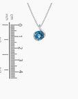 London Blue Topaz Monarch Pendant Necklace in Sterling Silver - Gift for her - next to a scale