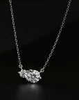 Moissanite Twin Pendant Necklace against a black backdrop, emphasizing the radiant shine of its lab-grown gemstones.