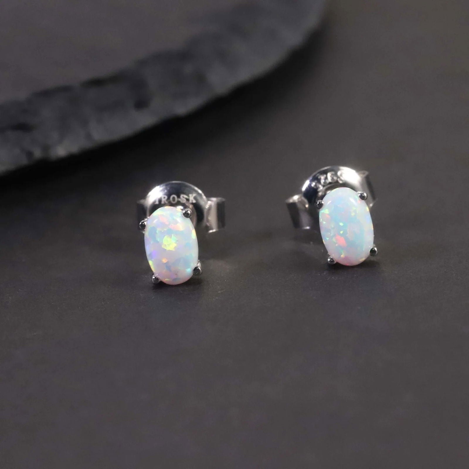 silver opal earrings in oval shape