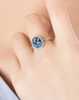 Alexandrite halo ring worn on finger – blue to purple gemstone jewellery for June birthdays