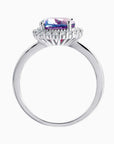 Side view of Alexandrite ring with raised oval gemstone and halo in sterling silver