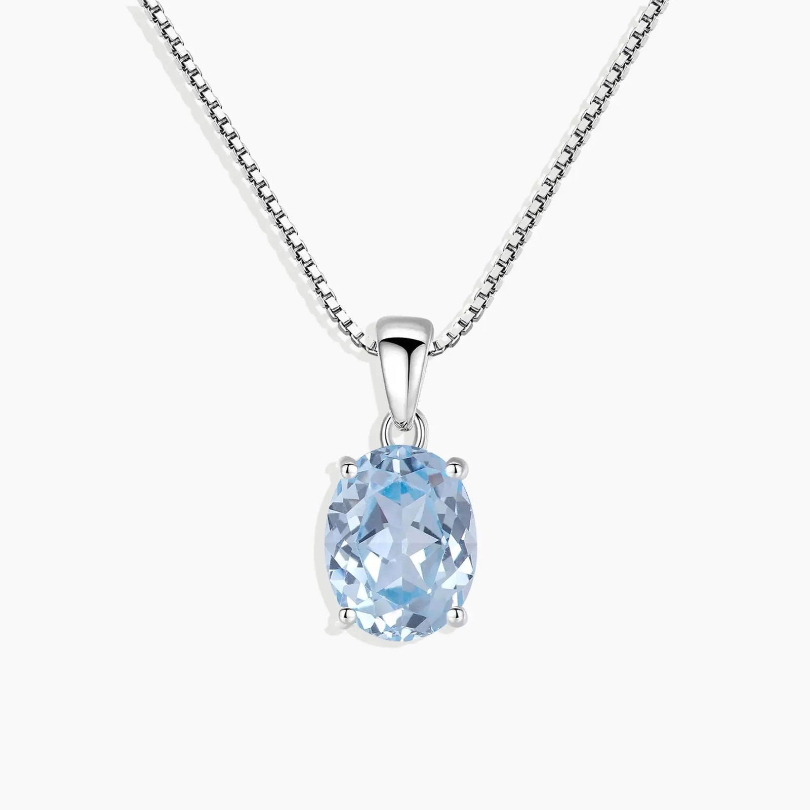 Oval aquamarine pendant in rhodium-plated sterling silver, displayed on a white background.