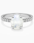 Oval moonstone ring in rhodium-plated sterling silver with CZ side accents by Irosk.