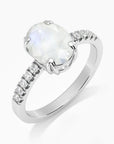 Elegant side view of the Irosk moonstone ring featuring a 9x7 mm oval-cut natural gemstone with sparkling CZ band