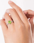 Model wearing Oval Peridot Silver Ring with Halo Design