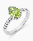 Close-up of a Sterling Silver Pear Cut Peridot Ring, showcasing its natural peridot stone and four-claw setting.