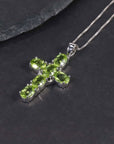 Close-up of Silver Cross Necklace with Natural Peridot Gemstones